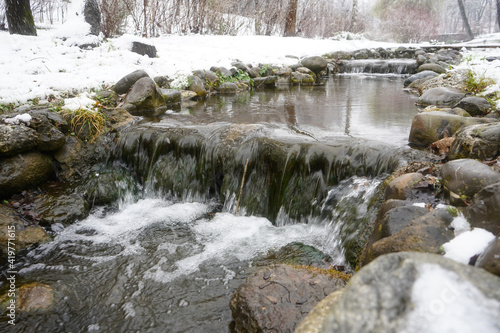 Waterfall of a river in winter. Photo during the day.