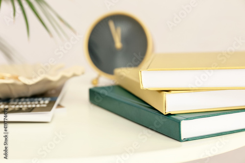 Stack of books on table aga...