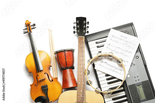 Different musical instruments and music notes on white background photo