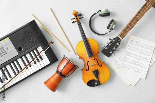 Different musical instruments and music notes on light background