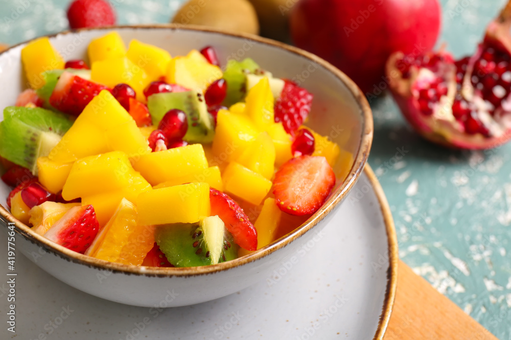 Bowl with mango salad on color background Bowl with mango salad on color background