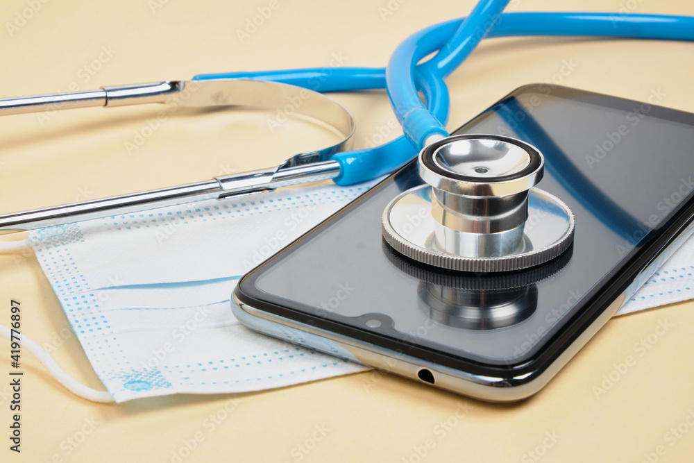 Doctor online concept, face mask with stethoscope, virtual hospital Doctor online concept, face mask with stethoscope, virtual hospital