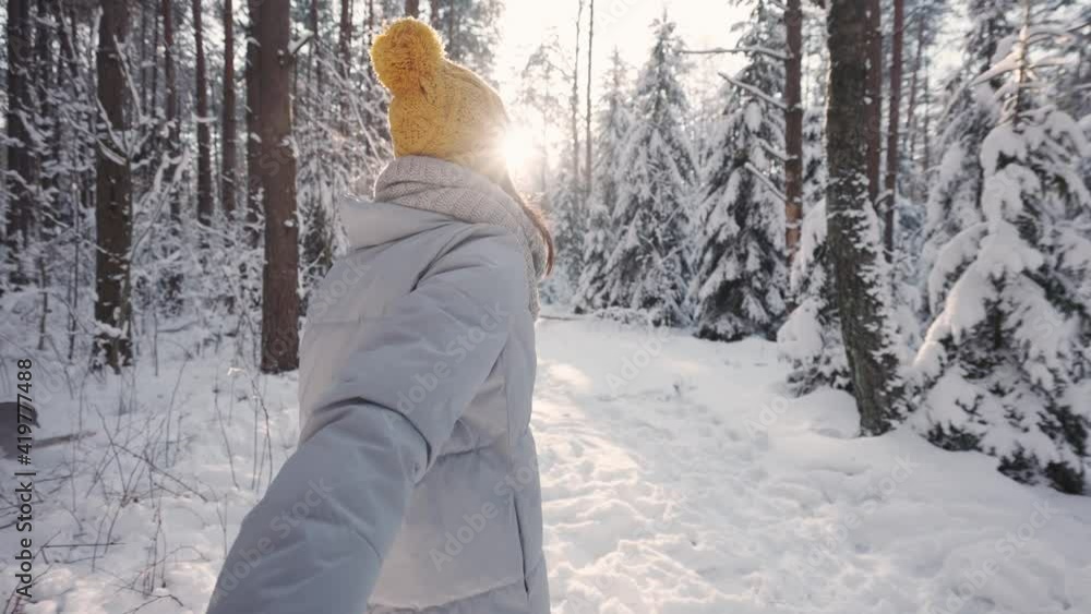 Follow me, winter walk through the forest with young female, first-person view, a beautiful girl holding hand and leads through the winter forest on a sunny day, pov. Follow me, winter walk through the forest with young female, first-person view, a beautiful girl holding hand and leads through the winter forest on a sunny day, pov.