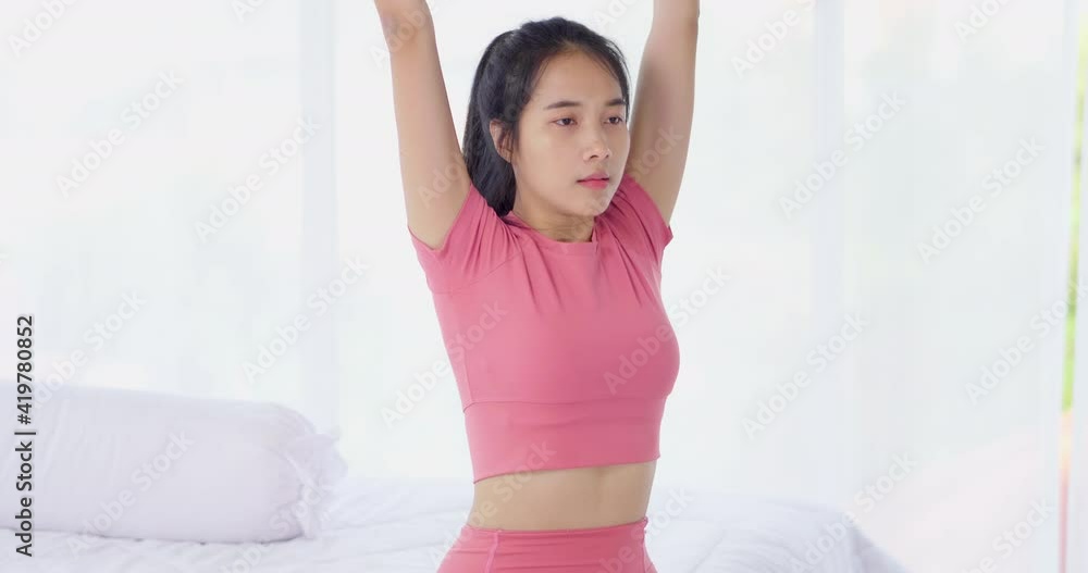 Asian woman arm muscle workout with yoga ball for weight training and yoga exercise at home in sexy sportswear. Take care health in quarantine coronavirus with new normal social distancing Asian woman arm muscle workout with yoga ball for weight training and yoga exercise at home in sexy sportswear. Take care health in quarantine coronavirus with new normal social distancing