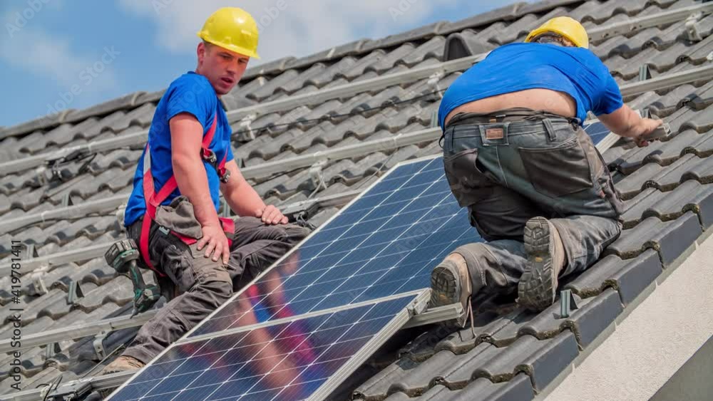 Two Guys Instal Solar Panels on Sloped Roof - Renewable Energy Source Two Guys Instal Solar Panels on Sloped Roof - Renewable Energy Source