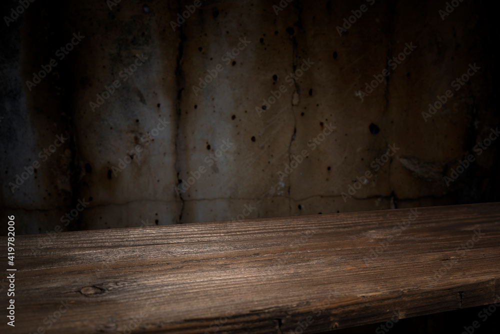 Selected focus empty brown wooden table and wall texture or old black brick wall blur background image. for your photomontage or product display Selected focus empty brown wooden table and wall texture or old black brick wall blur background image. for your photomontage or product display