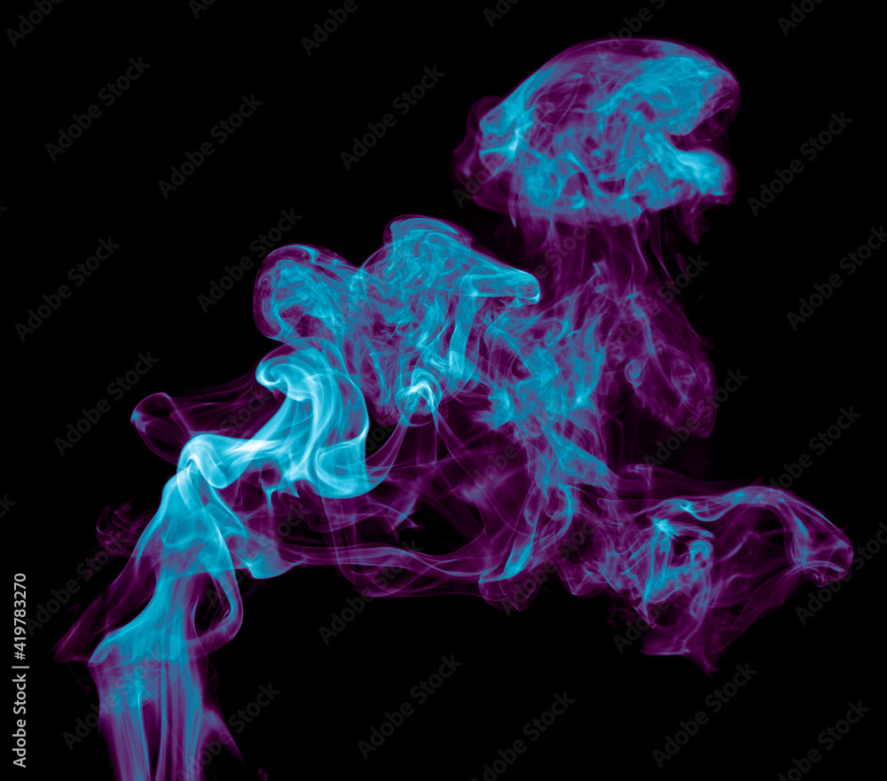 Fototapeta premium Purple and blue smoke isolated on black background. Abstraction