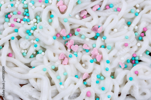 The texture of icing on a cake with pastry sprinkles, macro photography