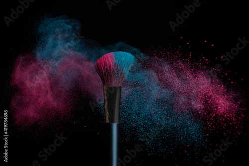 Blue and pink makeup on powder brush hit in a mixed cloud