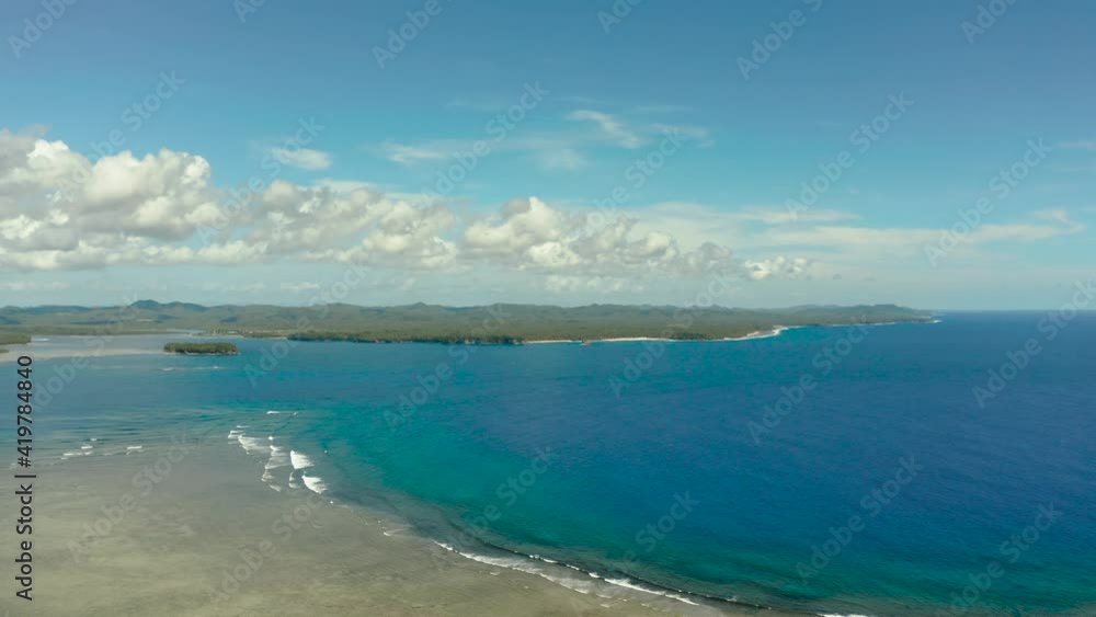 Tropical island with forest and ocean with surf and coral reef top view. Summer and travel vacation concept Tropical island with forest and ocean with surf and coral reef top view. Summer and travel vacation concept