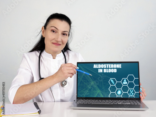  ALDOSTERONE IN BLOOD text in search bar. internistlooking for something at laptop. photo