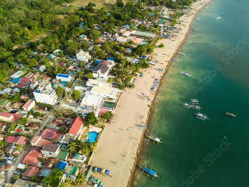 A typical resort town in the Philippines with buildings right up to the edge of the coastline. At Calayo, Nasugbu, Batangas. photo