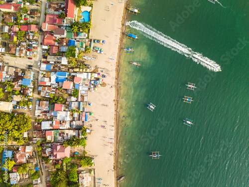 Top view of a resort town and beach. A visible stream caused by a jet ski moving to deeper waters. At Calayo, Nasugbu, Batangas. photo