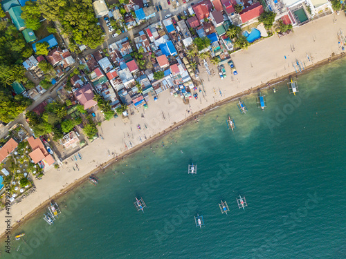 A typical resort town in the Philippines with buildings right up to the edge of the coastline. At Calayo, Nasugbu, Batangas. photo