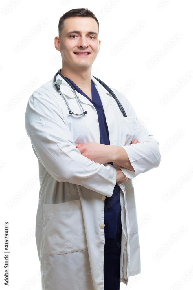 Men in Business. Natural Portrait of Professional Confident Male GP Doctor Posing in White Doctor's Smock With Endoscope and Hands Folded in Front on White. Men in Business. Natural Portrait of Professional Confident Male GP Doctor Posing in White Doctor's Smock With Endoscope and Hands Folded in Front on White.
