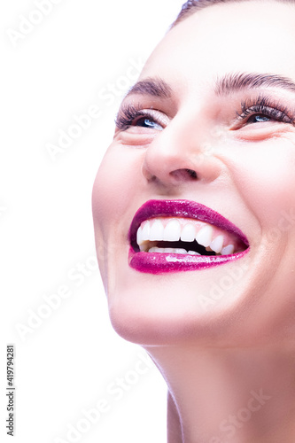 Beauty Portrait of Smiling Happy Caucasian Woman with Fresh and Clean Skin Posoing Against White Background.