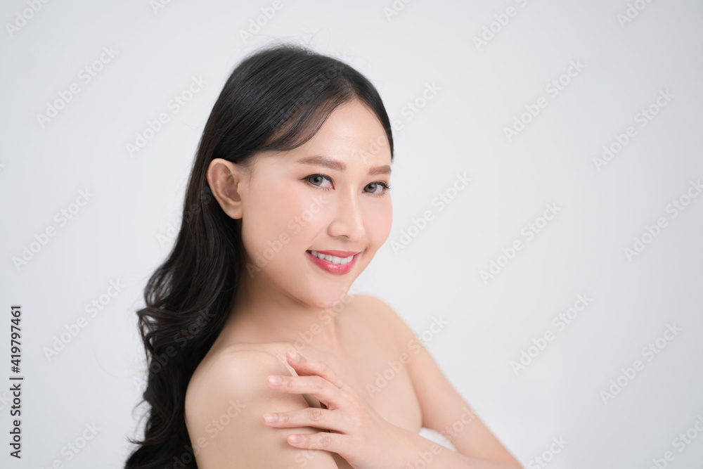 Youthful bright skin of a beautiful Asian woman is isolated from a white background. Youthful bright skin of a beautiful Asian woman is isolated from a white background.