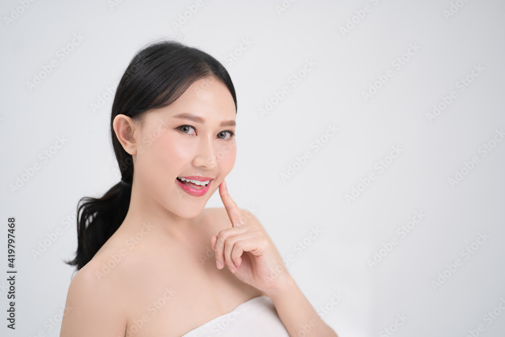 Youthful bright skin of a beautiful Asian woman is isolated from a white background. She was smiling and happy. Youthful bright skin of a beautiful Asian woman is isolated from a white background. She was smiling and happy.
