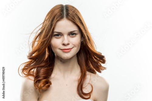 portrait of a woman with bare shoulders red hair cosmetics 