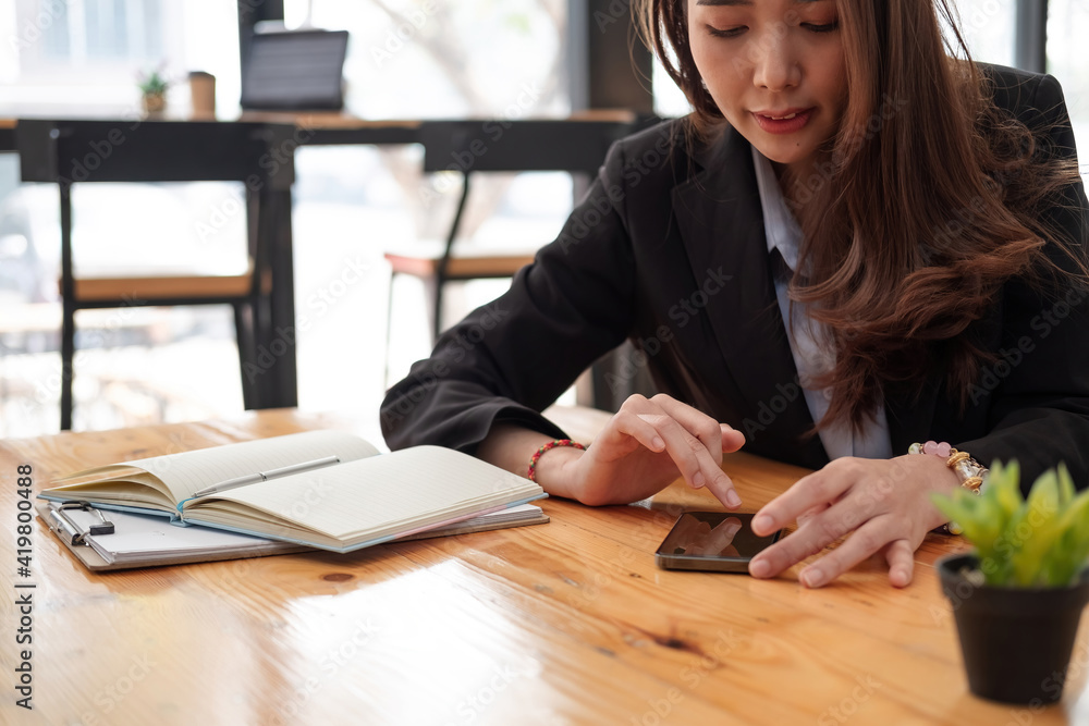business, technology concept - Portrait of woman hands texting message on smartphone at office. business, technology concept - Portrait of woman hands texting message on smartphone at office.