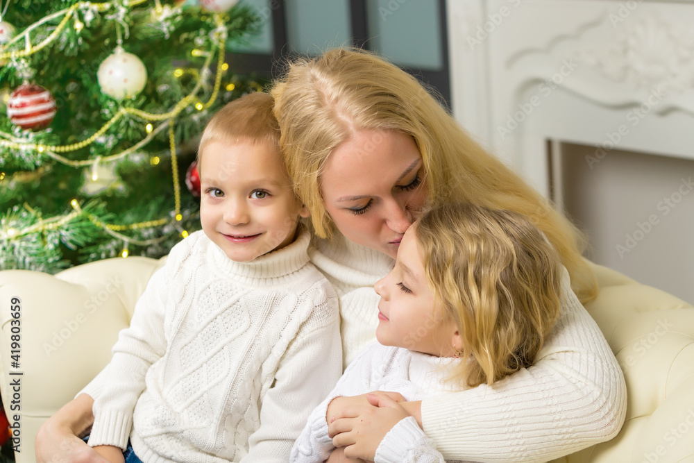 Happy Family Sitting on the Sofa in Christmas Interior. Happy Family Sitting on the Sofa in Christmas Interior.
