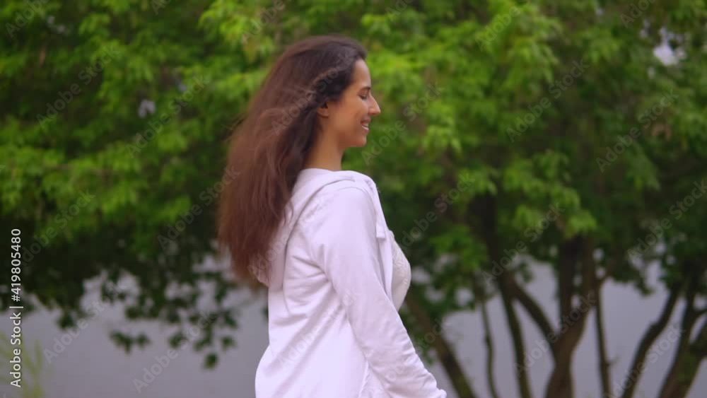 side view happy young woman walking in park joyful tourist whirling on the street slow motion on the background green landscap side view happy young woman walking in park joyful tourist whirling on the street slow motion on the background green landscap