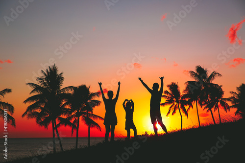 a family of three by the seas at sunset, palm trees silhouette beautiful sky, Kakaako Waterfront Park, Honolulu, Oahu, Hawaii