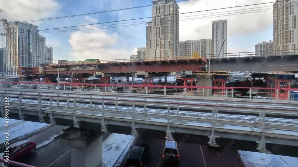 Urbanisation, a view from a train window of the construction of a multi-lane overpass running through residential and industrial areas Urbanisation, a view from a train window of the construction of a multi-lane overpass running through residential and industrial areas