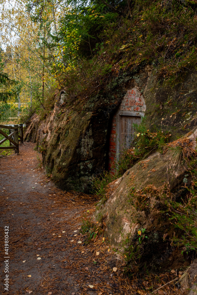 Cellar cliffs in Cave Rock (Lustuzis) in Ligatne, Latvia during cloudy autumn day that were used for storage of goods