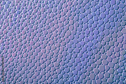 Imitation of purple scales. Abstract background with artificial leather shot close-up. Stock macro texture
