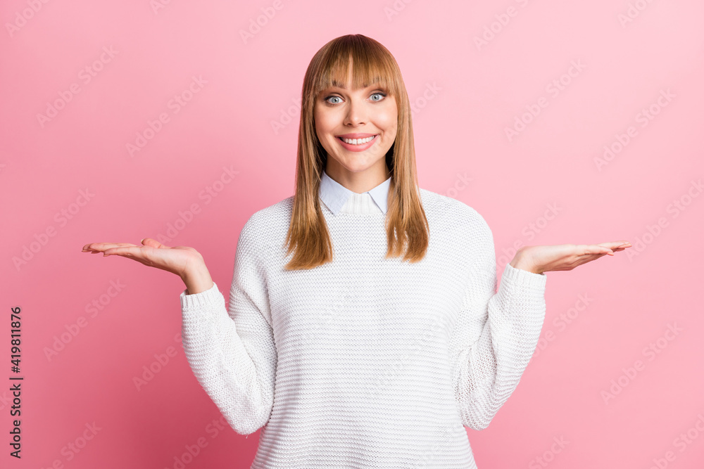 Photo of young happy cheerful good mood smiling woman hold hands in balance recommendation isolated on pink color background Photo of young happy cheerful good mood smiling woman hold hands in balance recommendation isolated on pink color background