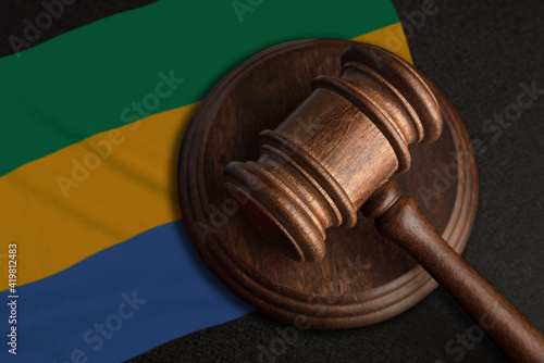 Judge gavel and flag of Gabon. Law and justice in Gabon. Violation of rights and freedoms photo