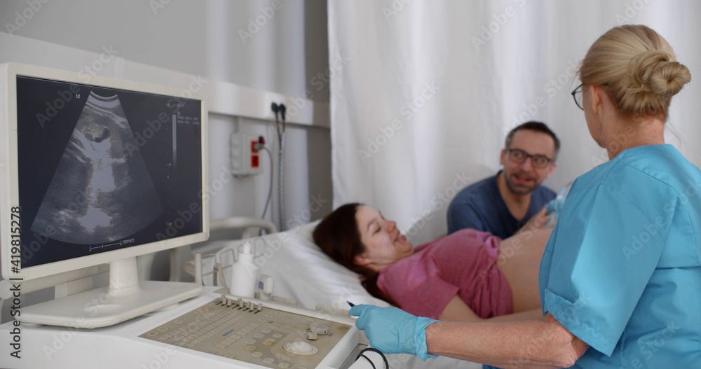 Expecting happy couple visiting doctor for ultrasound test. Expecting happy couple visiting doctor for ultrasound test.
