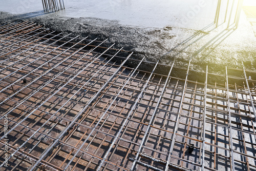 Pouring concrete onto a steel reinforced platform.