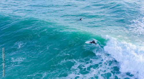 Aerial drone view of surfers riding perfect Atlantic waves in the south coast of Spain, Caños de Meca near Trafalgar © Pablo