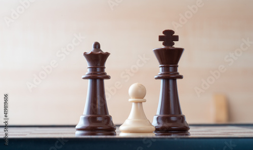 small pawn on chess board against larger adversary concept of adversity ,discimination ,equality .