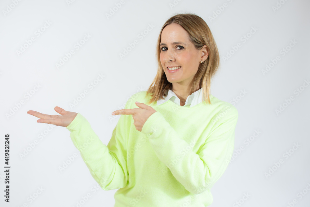 Smiling woman pointing finger side. Isolated portrait on white. Smiling woman pointing finger side. Isolated portrait on white.