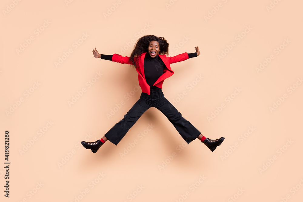 Full body photo of dark skin funky positive young woman jump up air enjoy weekend isolate don beige color background Full body photo of dark skin funky positive young woman jump up air enjoy weekend isolate don beige color background