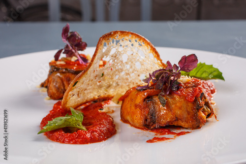 Antipasto con involtini di melanzane cotti nel sugo e chips di pane  photo