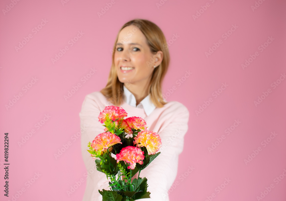Valentines day, romance, celebration and beauty concept. Charming elegant and feminine young woman receive flowers, holding beautiful bouquet and laughing joyfully, pink background
