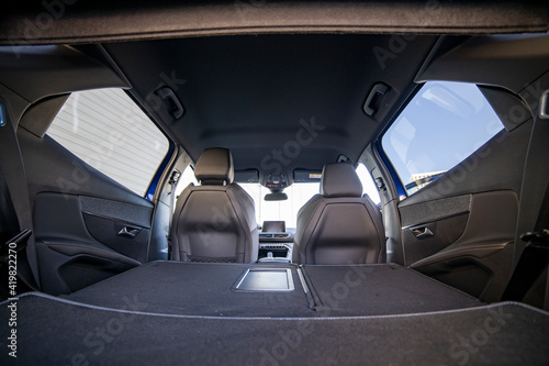 empty trunk of a modern car with folded rear seats. large interior volume. trunk view