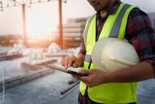 Engineering Consulting People on construction site holding tablet in his hand. Management in business workflow and Building inspector with BIM technology in Construction Project.
