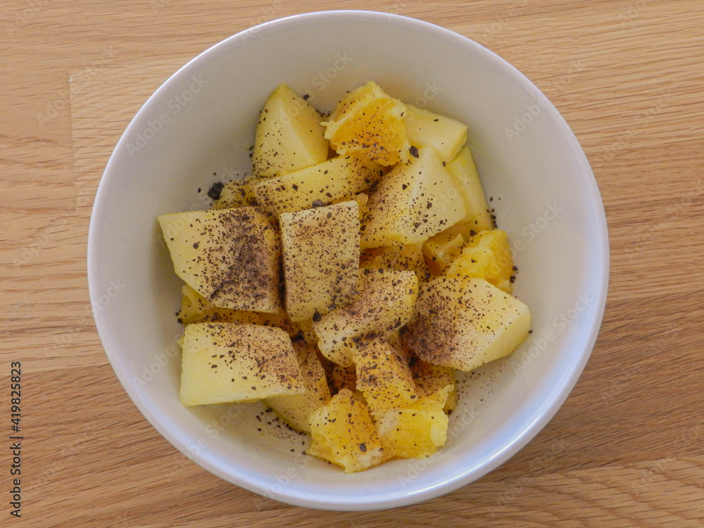 Orange and apple pieces in a bowl with some chocolate on top Orange and apple pieces in a bowl with some chocolate on top