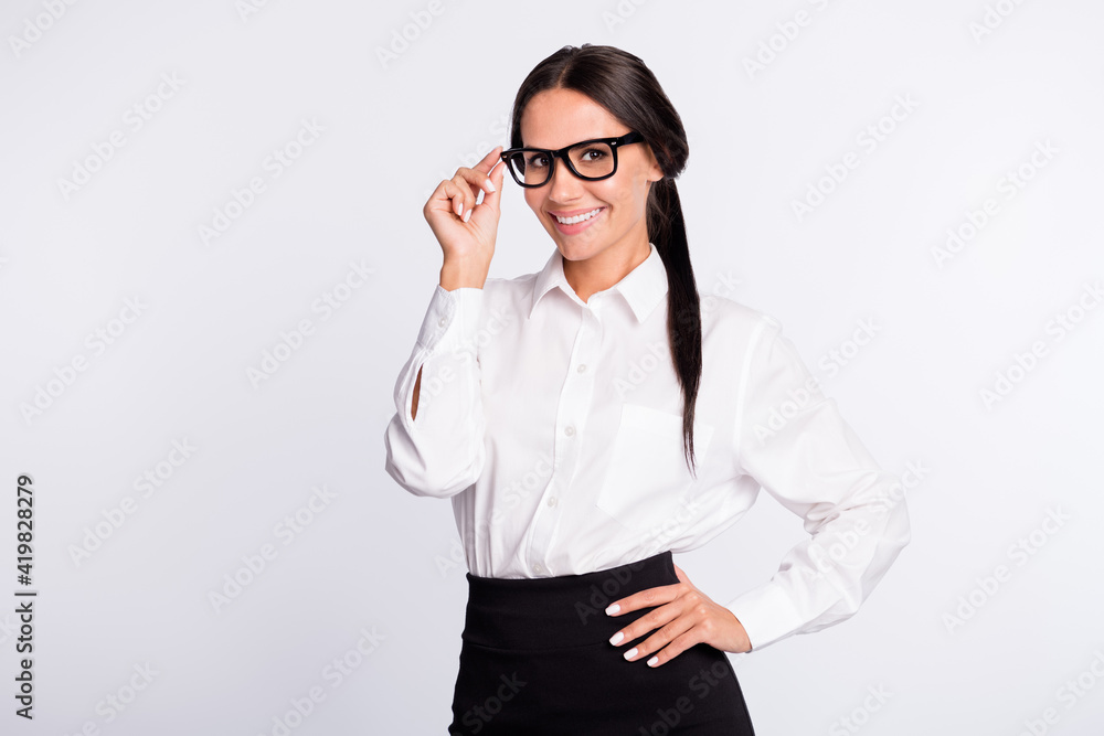 Photo of optimistic brunette hairdo lady stand wear spectacles shirt isolated on grey color background Photo of optimistic brunette hairdo lady stand wear spectacles shirt isolated on grey color background