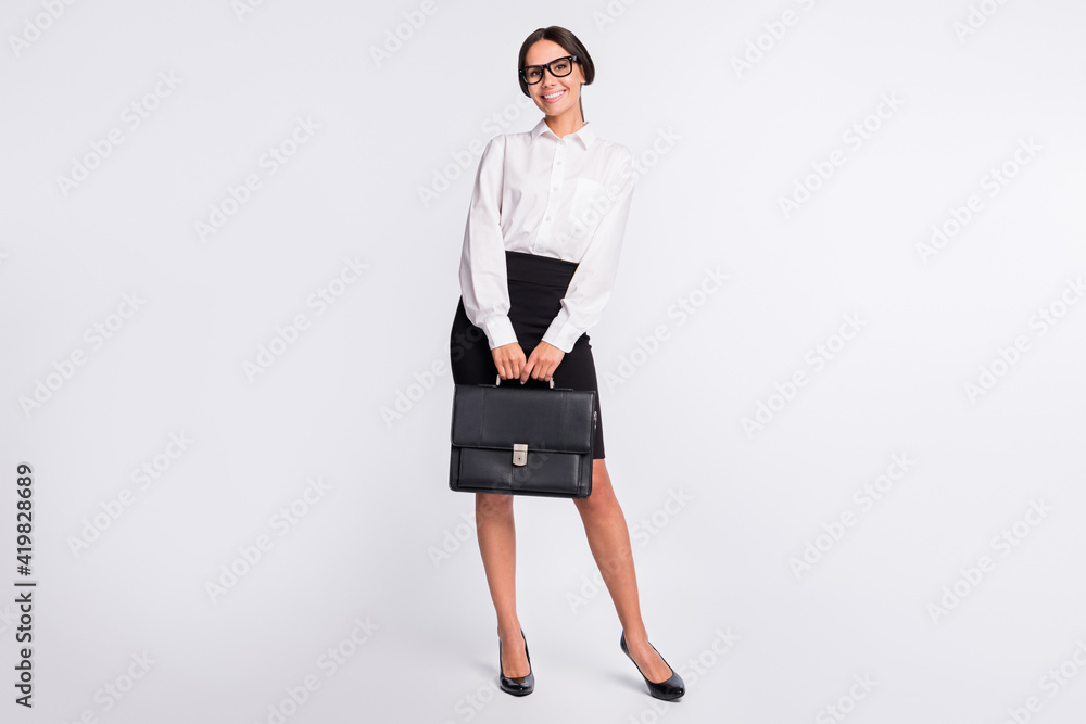 Full size photo of optimistic brunette hairdo lady stand wear spectacles shirt skirt isolated on grey color background Full size photo of optimistic brunette hairdo lady stand wear spectacles shirt skirt isolated on grey color background