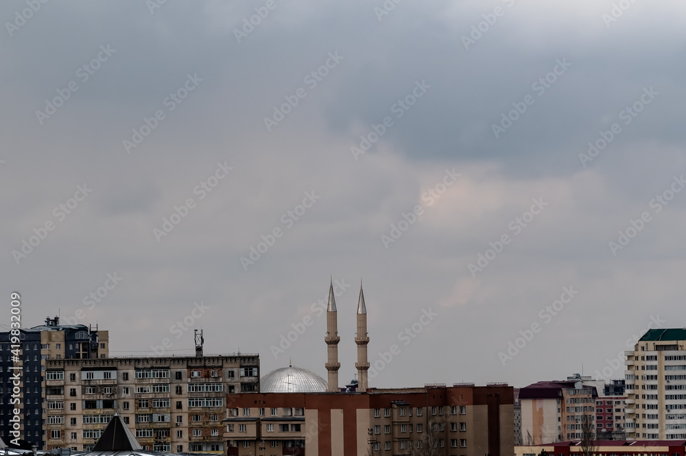 minarets in the gray sky over the city 