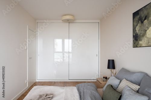 Bedroom with big white wardrobe