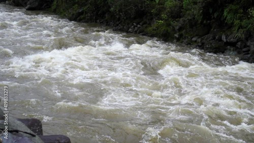 Pan Of Roaring River Rapids Pounding Along River With Lush Jungle Banks