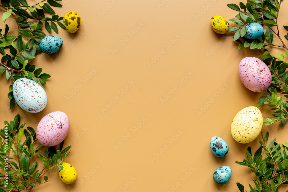 Colorful eggs with green tree. Easter decoration background. Top view