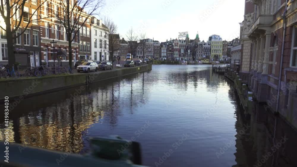 Amsterdam canal Spring scene with bicycles and bridges, Old Dutch Building Reflection in water Amsterdam canal Spring scene with bicycles and bridges, Old Dutch Building Reflection in water